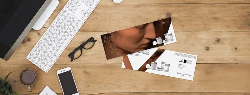 Campaign direct mail on table with computer, glasses and phone